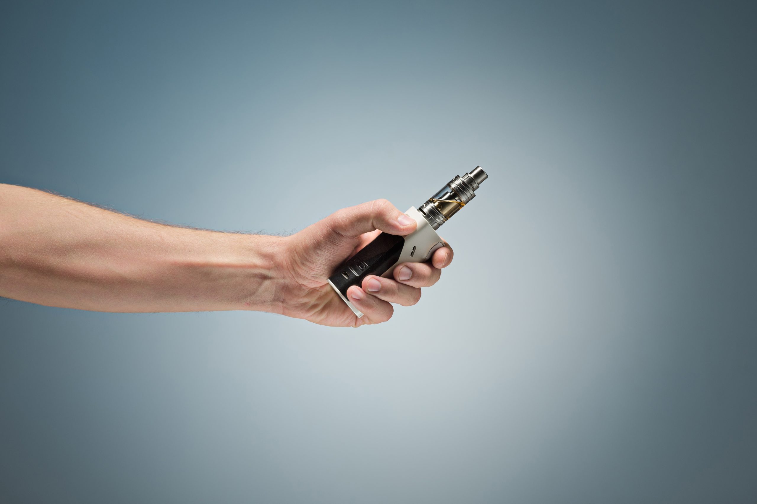 hand holding electronic cigarette scaled