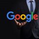 businessman suit holds google logo
