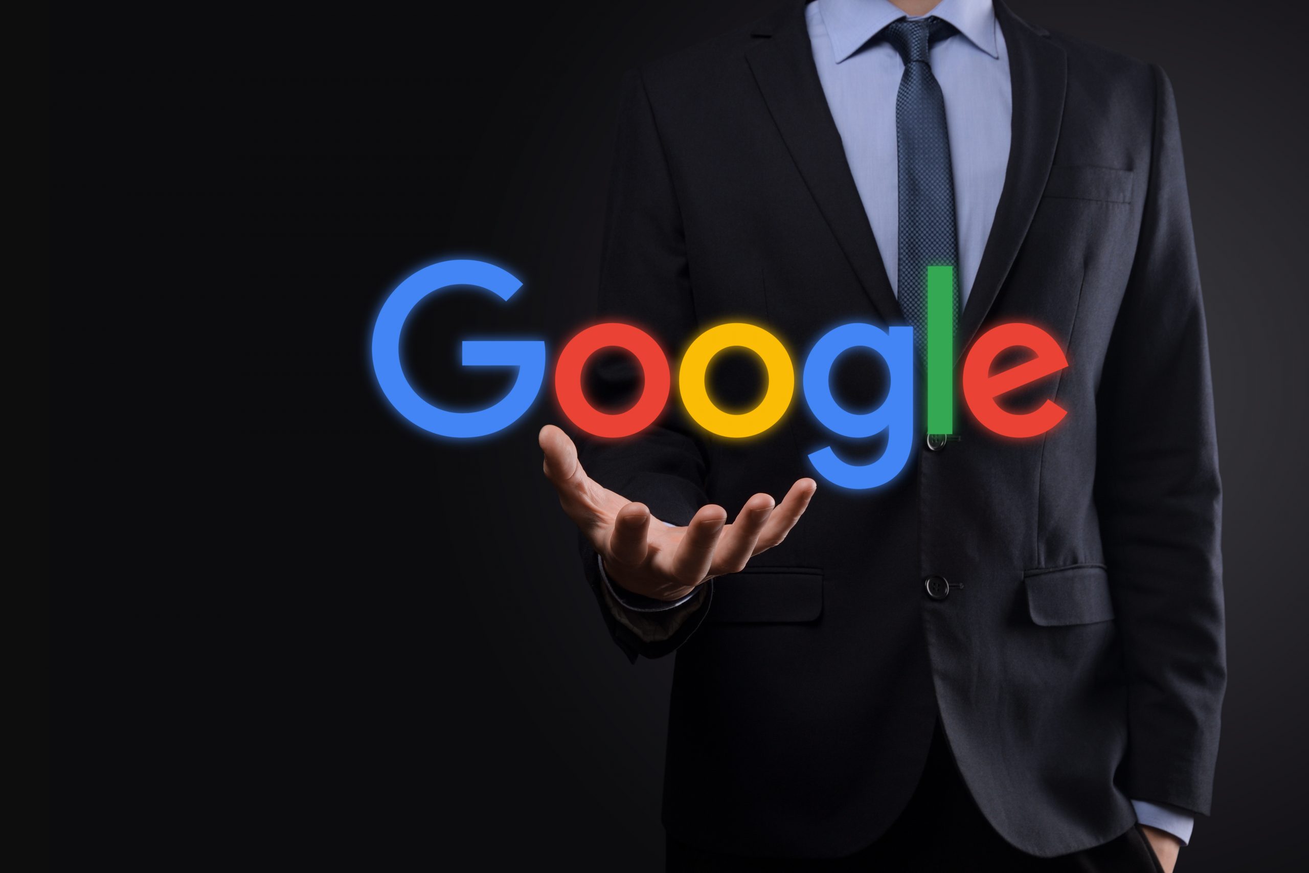 businessman suit holds google logo scaled