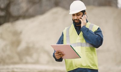 indian man working male yellow vest man with folder