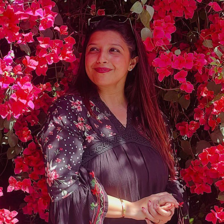 Like a bougainvillea—flourishing on neglect surviving impossible summers and still somehow acc